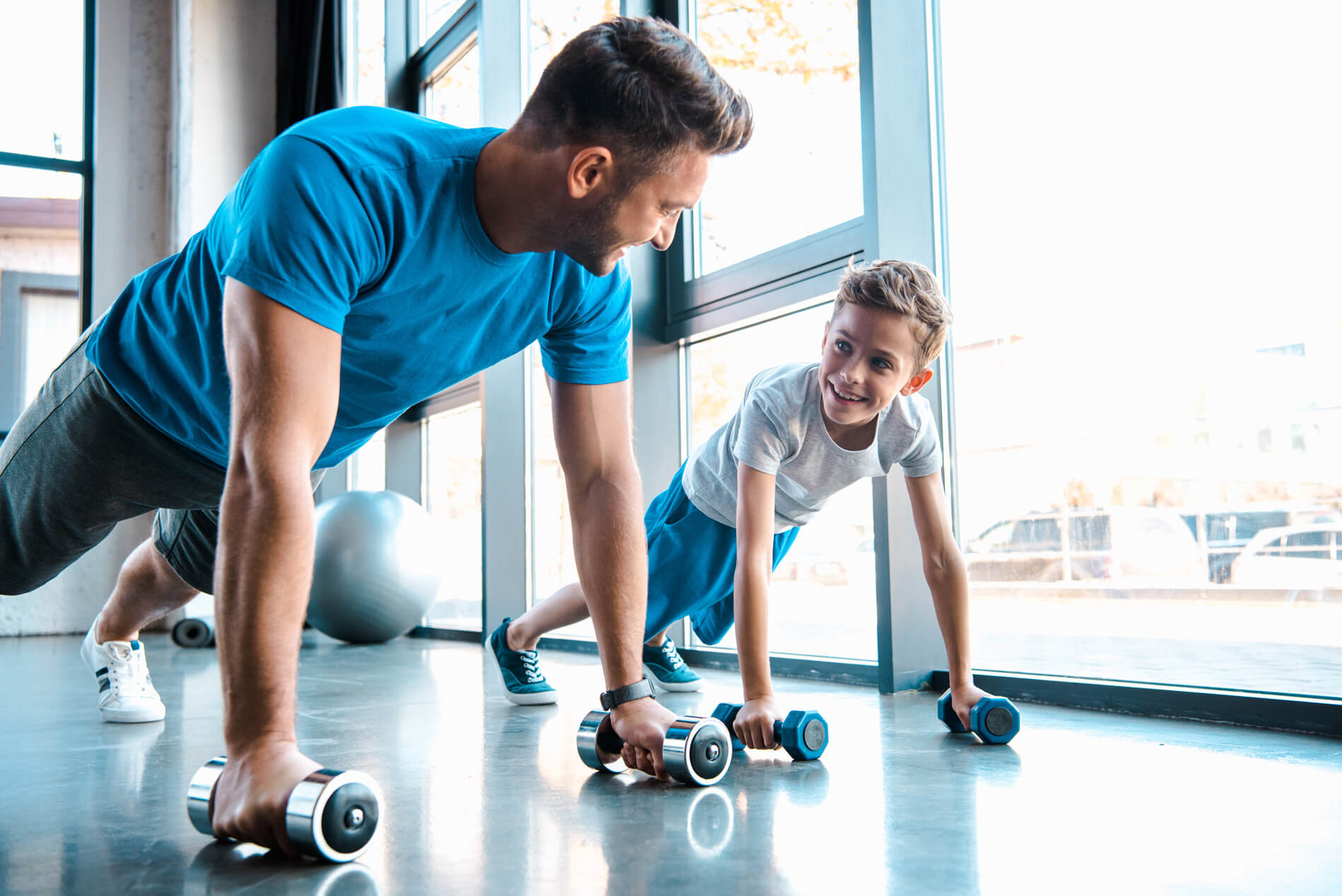 Man and young boy working out in the gym