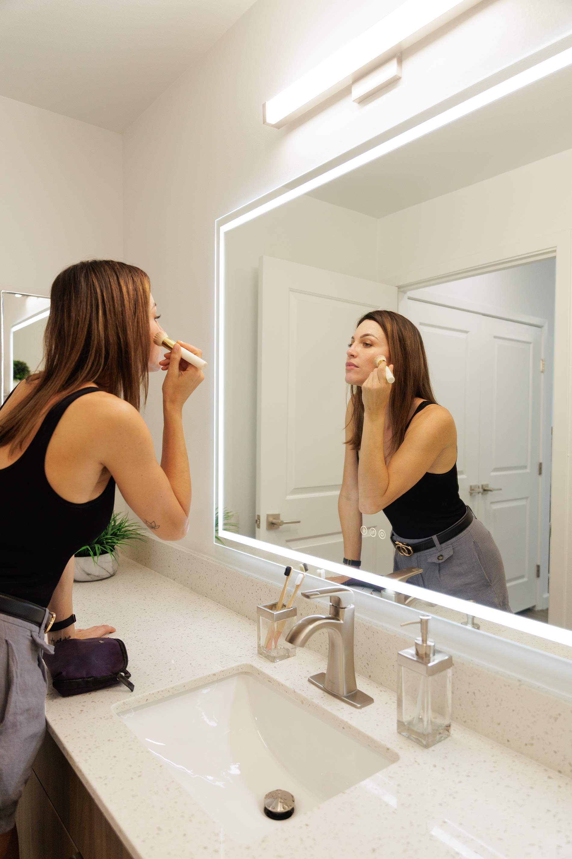 Island Square woman gets ready in bathroom