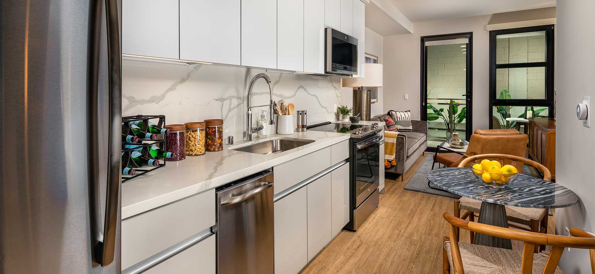 Stylish apartment kitchen with quartz countertops and stainless steel appliances