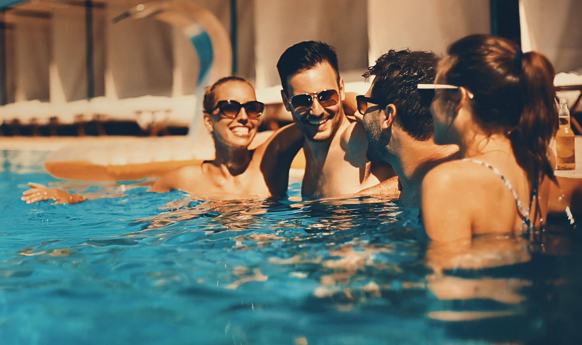 Friends laughing in the swimming pool