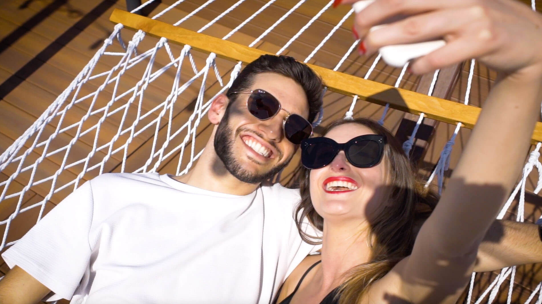 People taking a selfie in a hammock