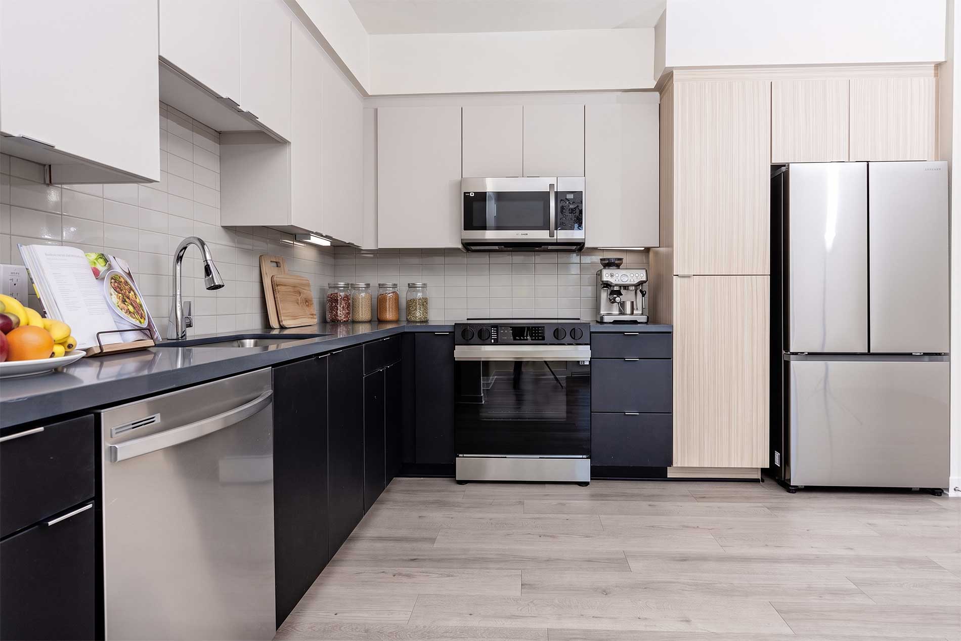 North Grove brand-new apartment kitchen in Riverside with quartz countertops and stainless steel appliances