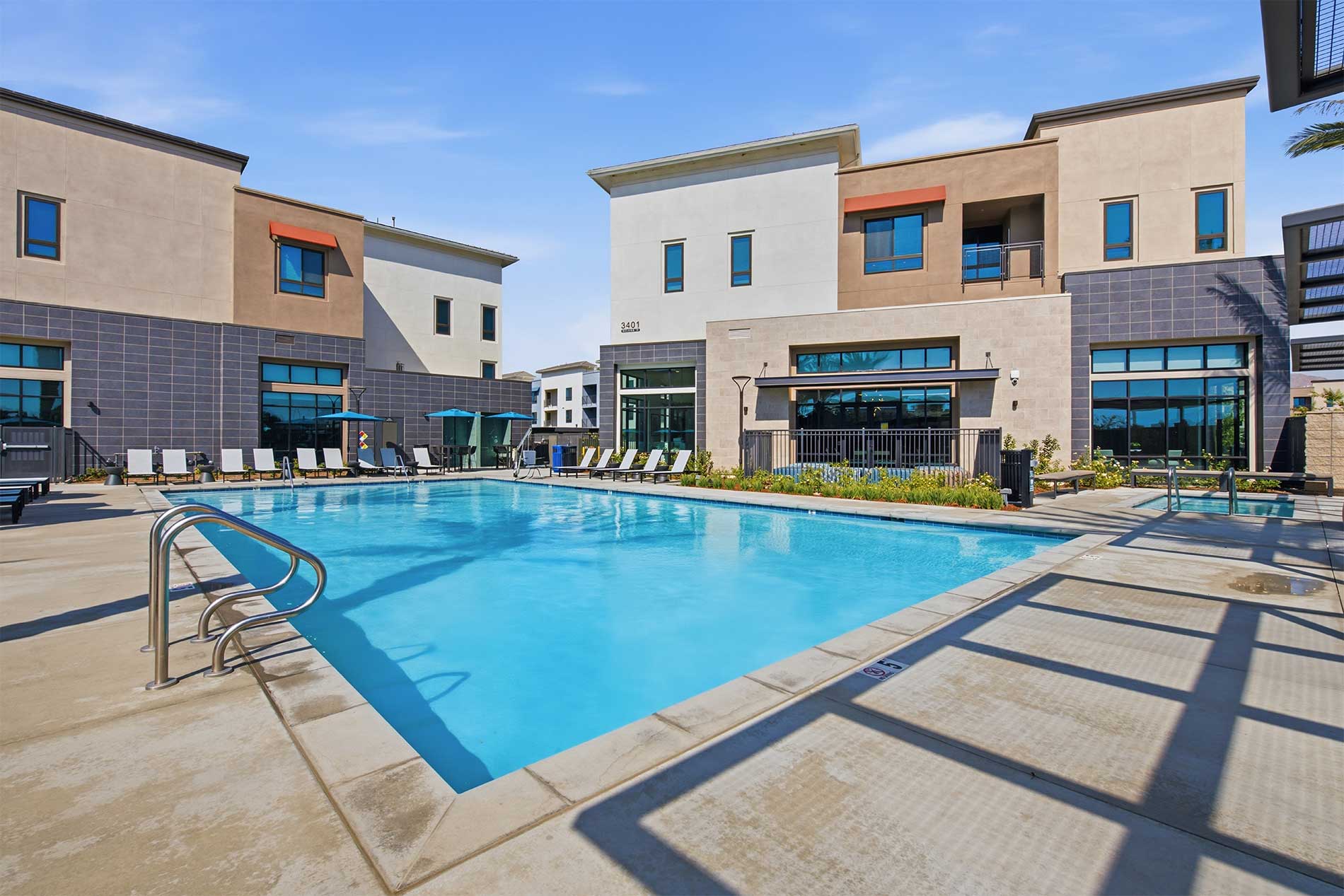 North Grove brand-new apartments in Riverside with resort-style swimming pool and lounge seating