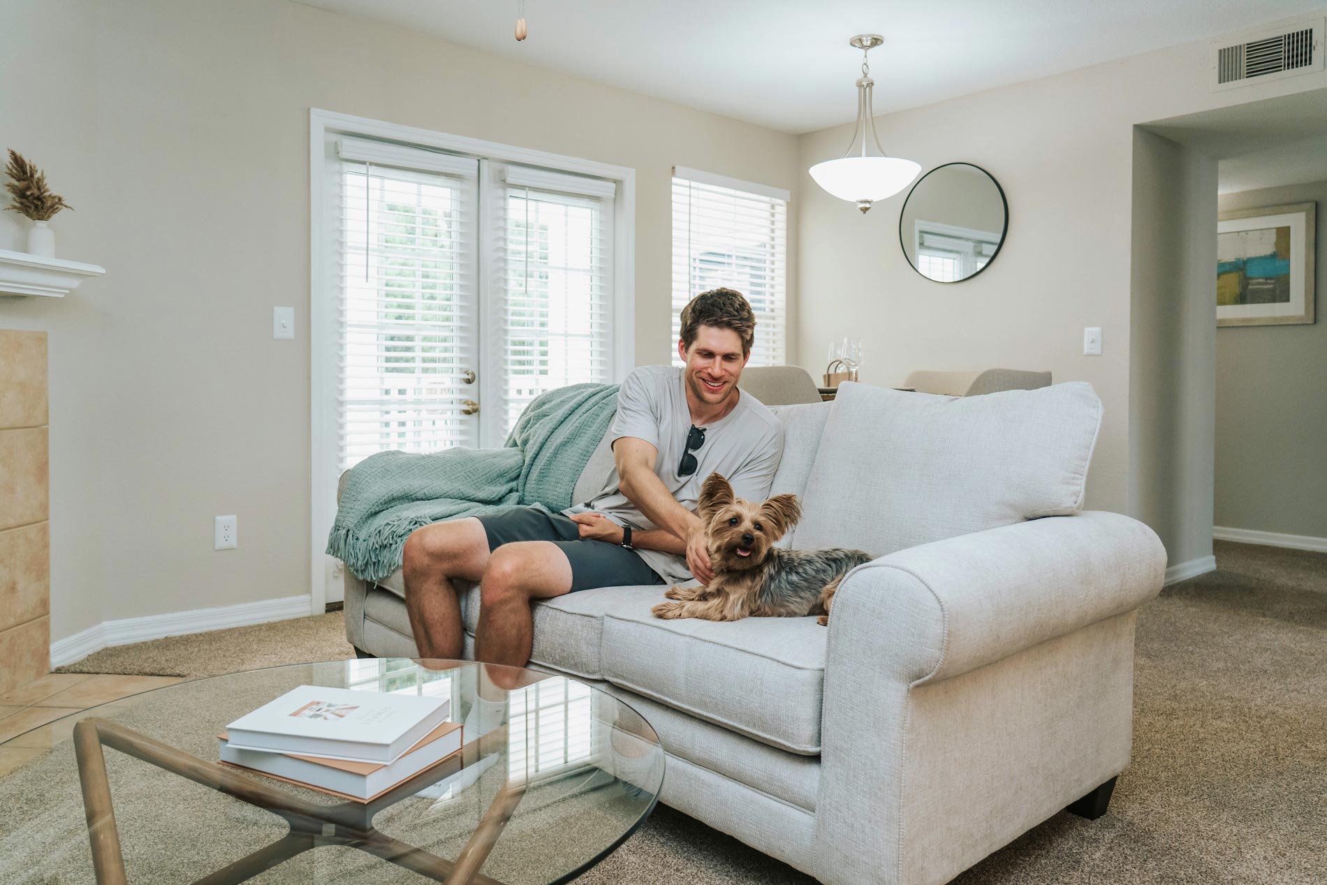 Polo Park man sits with dog in living room