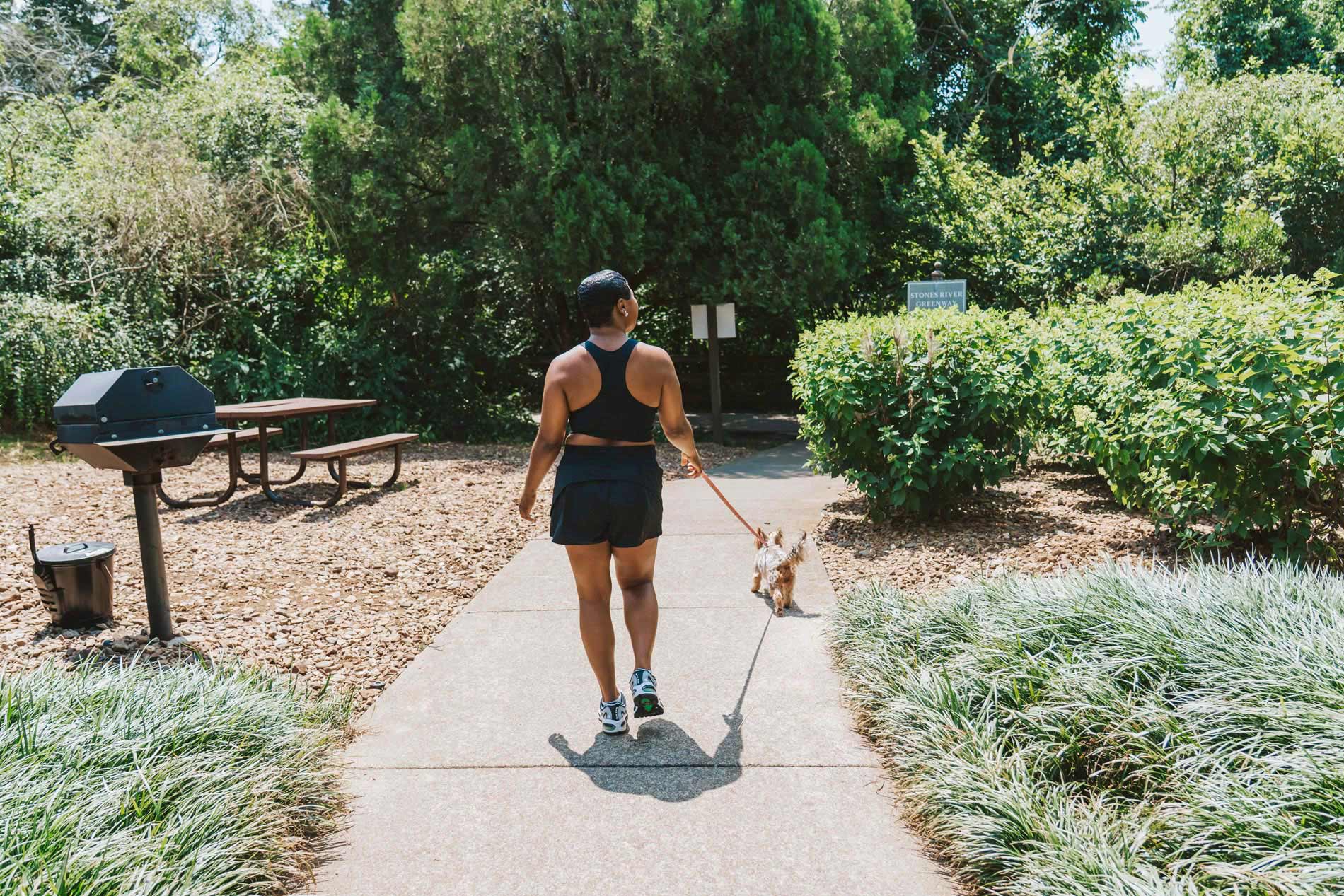 Polo Park woman walks dog down path
