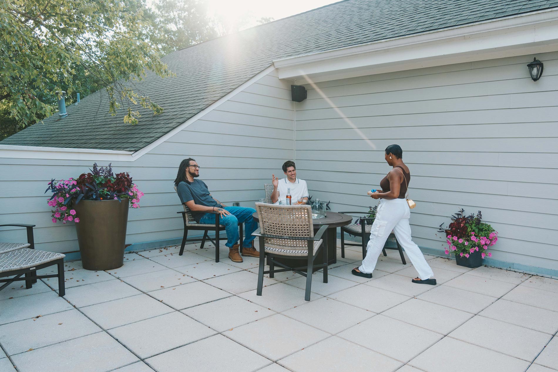 Polo Park three people sit by firepit