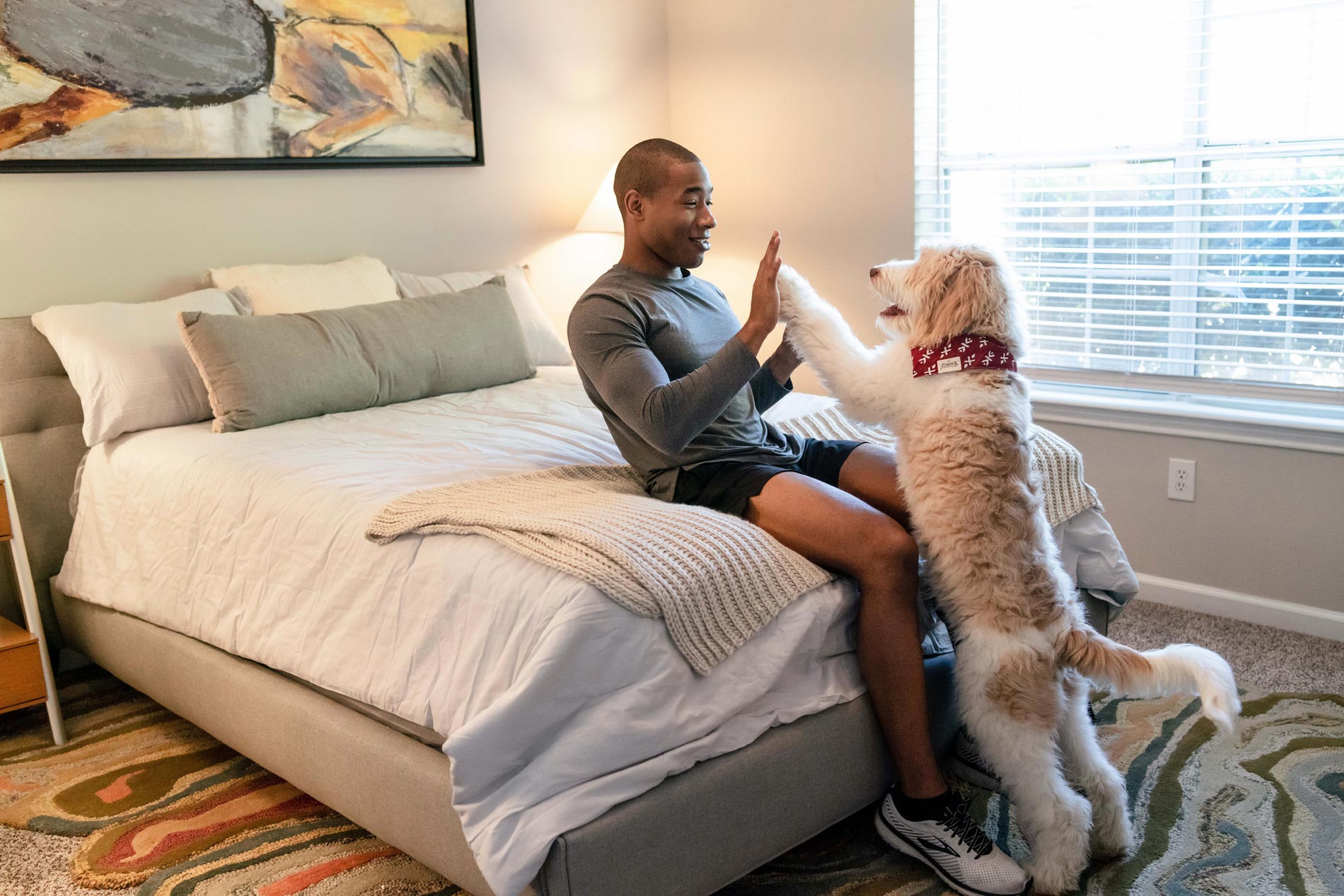 Preserve at Brentwood young man and dog in apartment bedroom