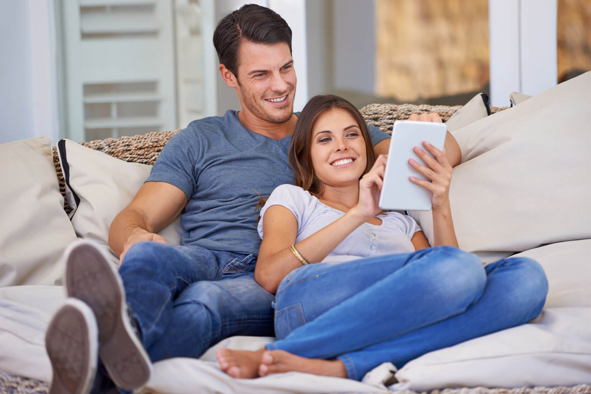 Man and woman lounging on couch