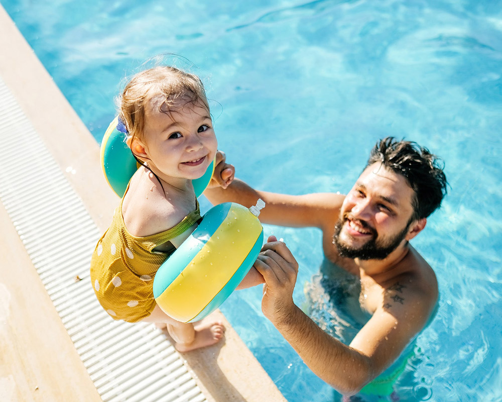 Father and child at the pool