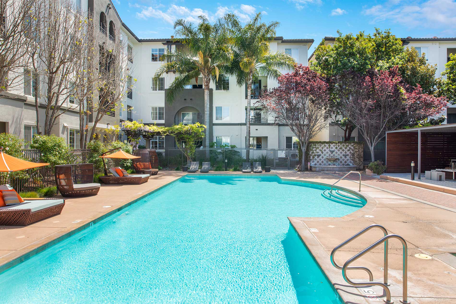 Outdoor pool and relaxing lounge area at River Terrace in Santa Clara.