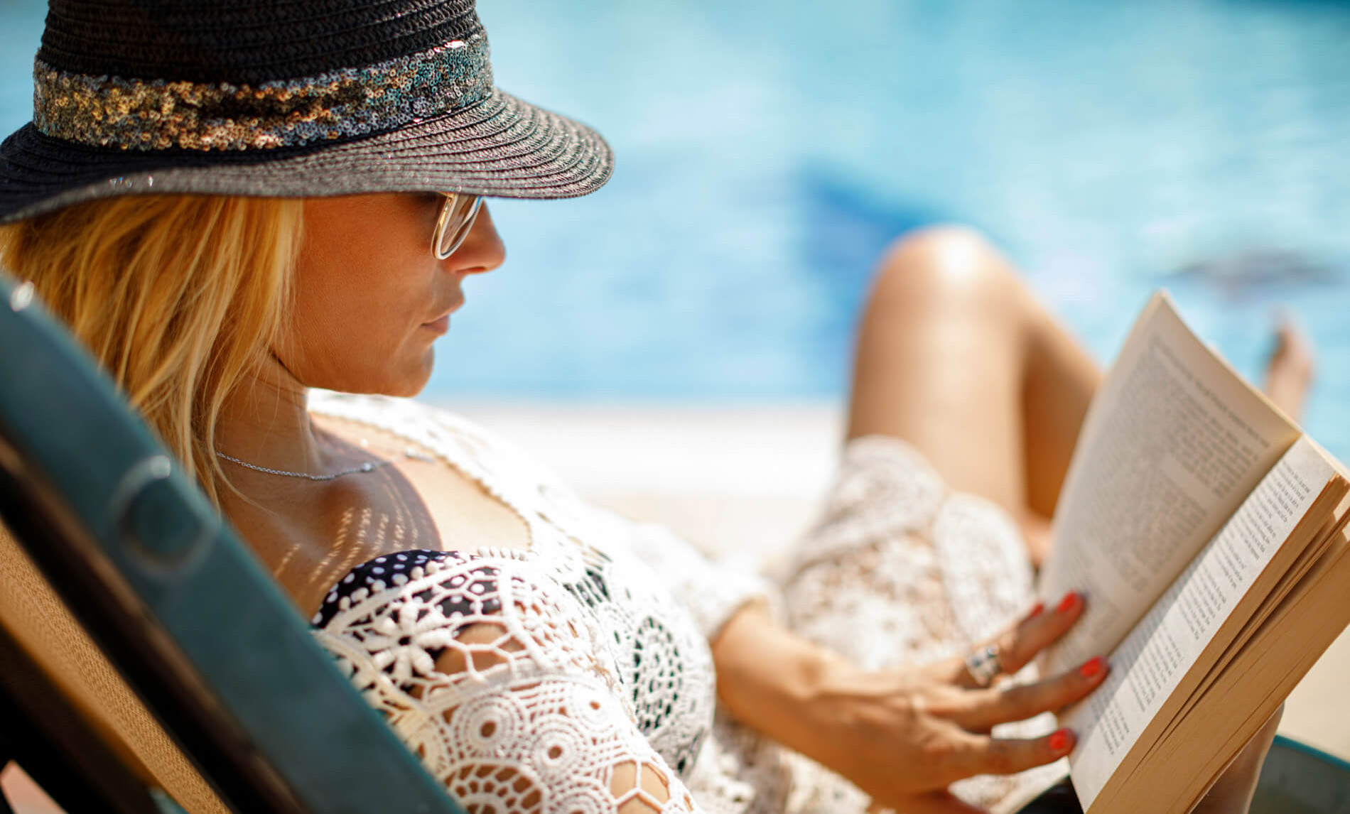 Girl reading by the pool