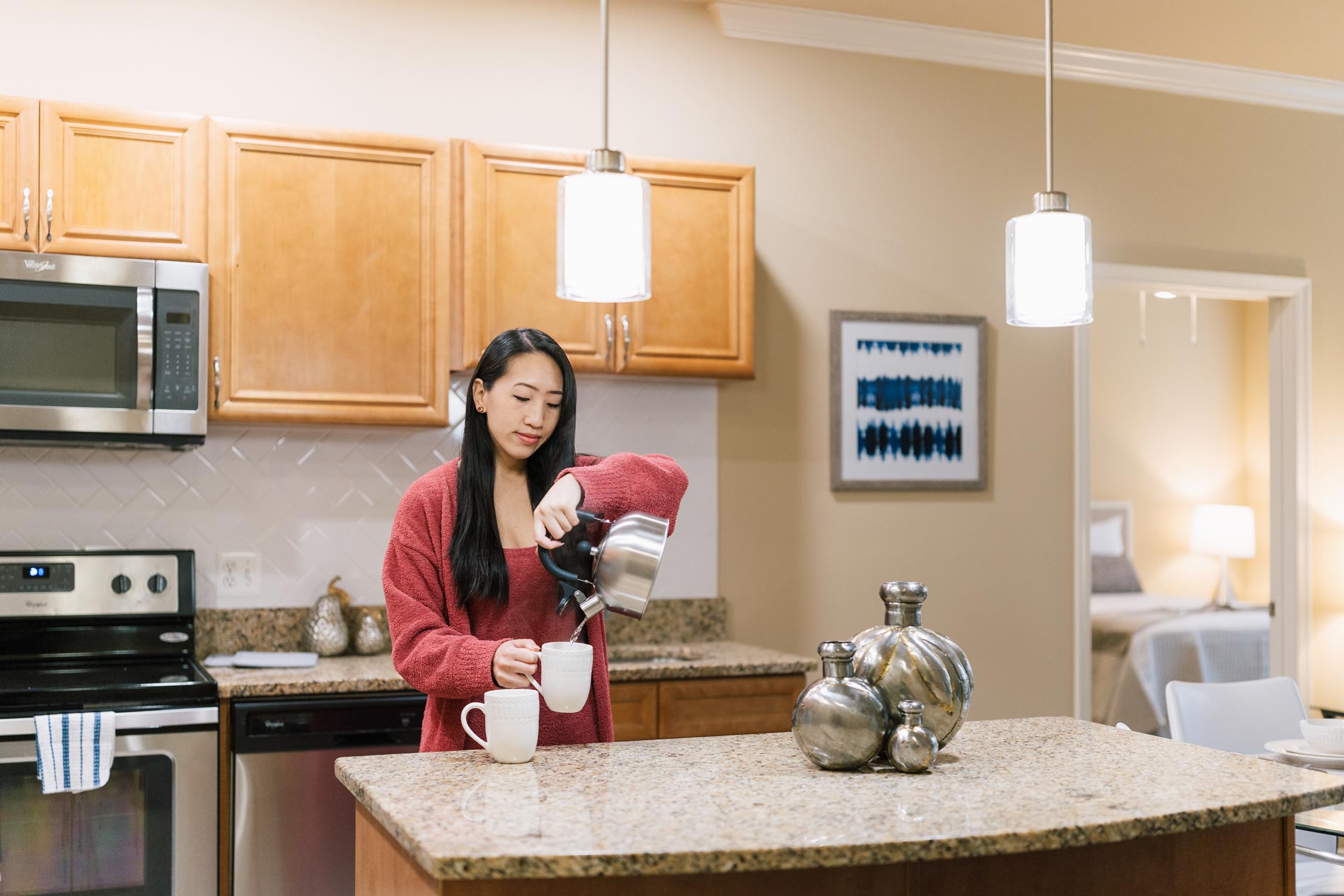 Signal Hill woman pours coffee in kitchen