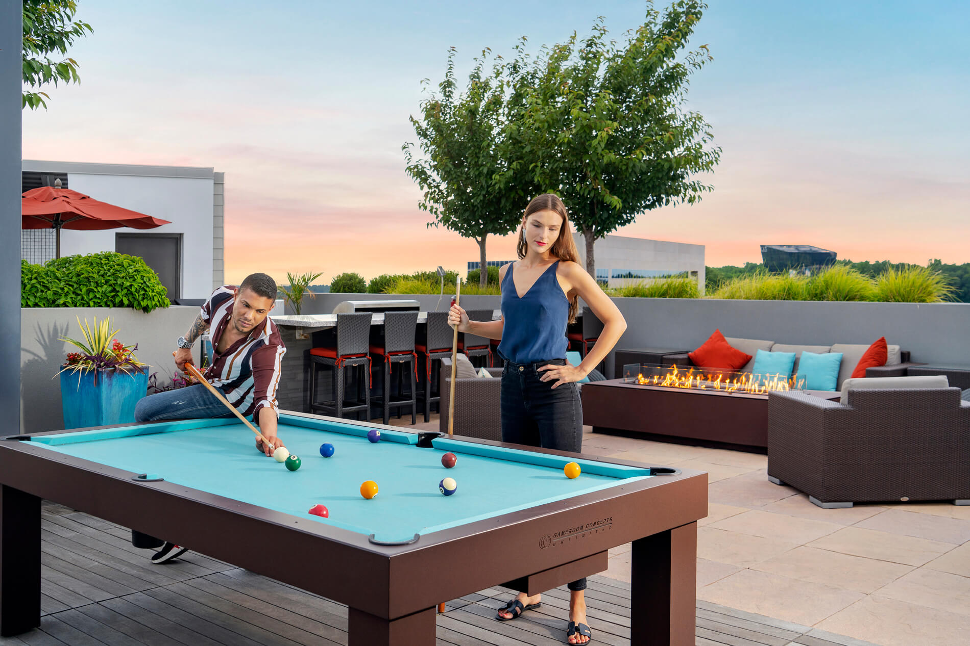 Couple playing pool on rooftop