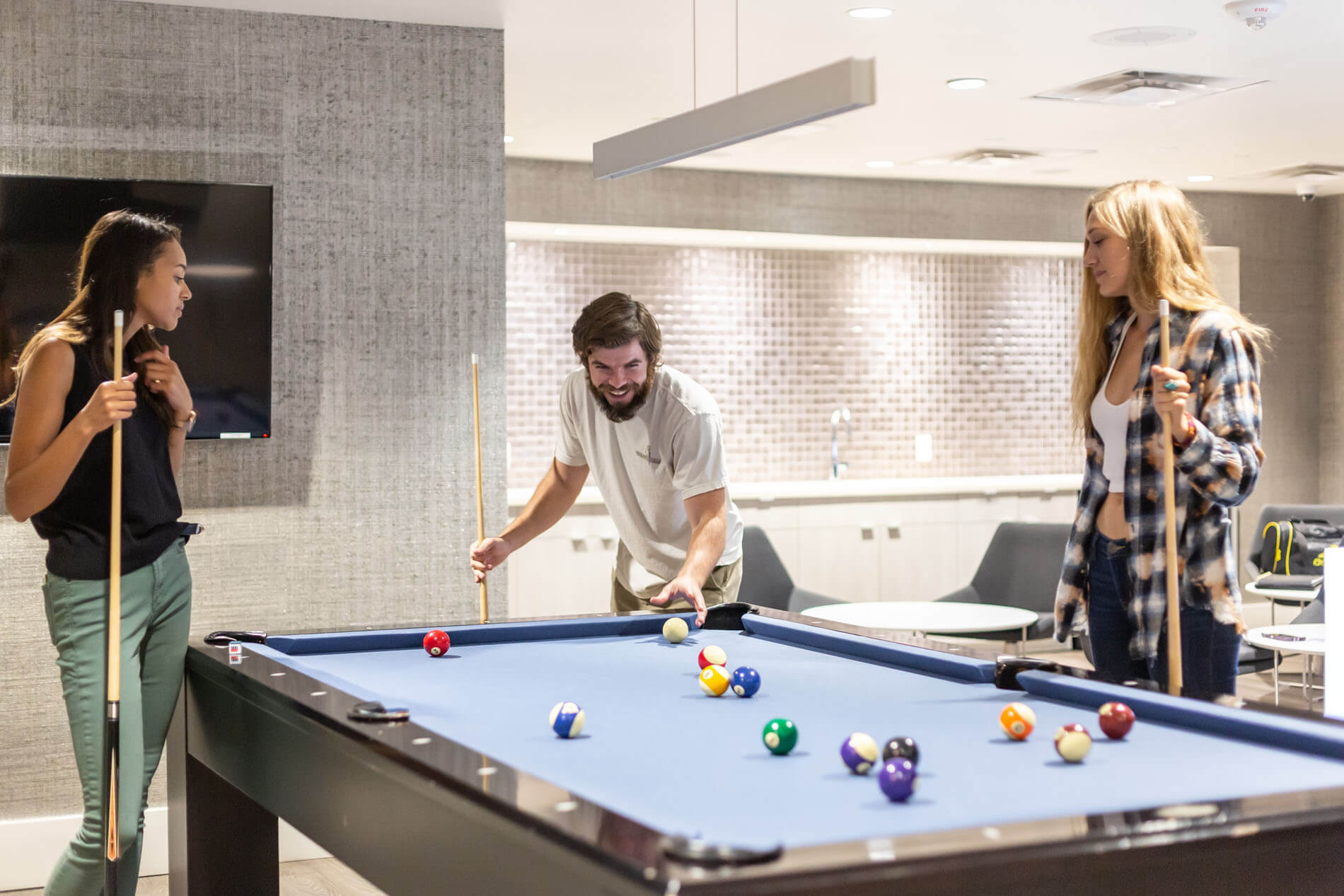 Friends playing billiards