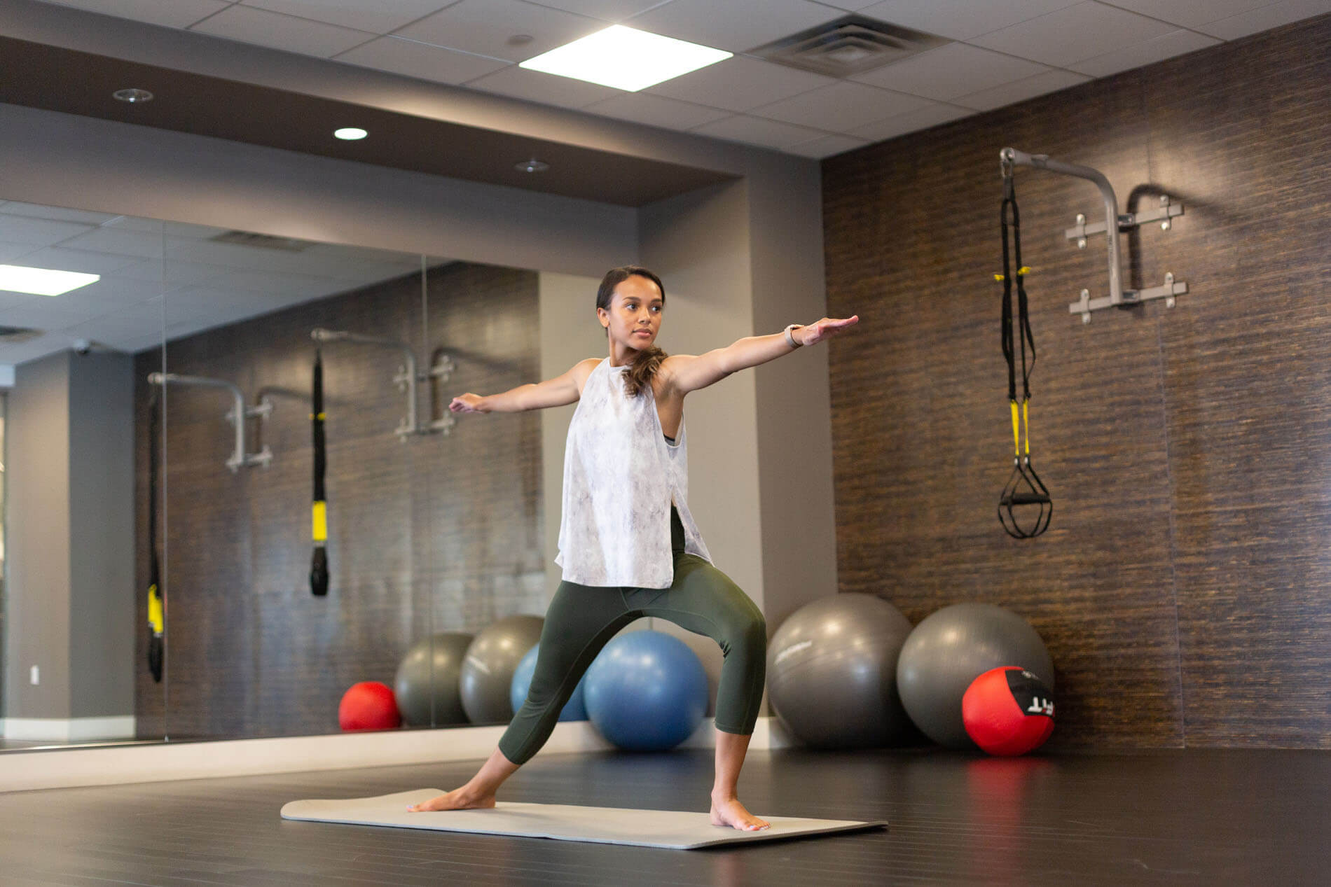 Woman holding yoga post in the fitness center