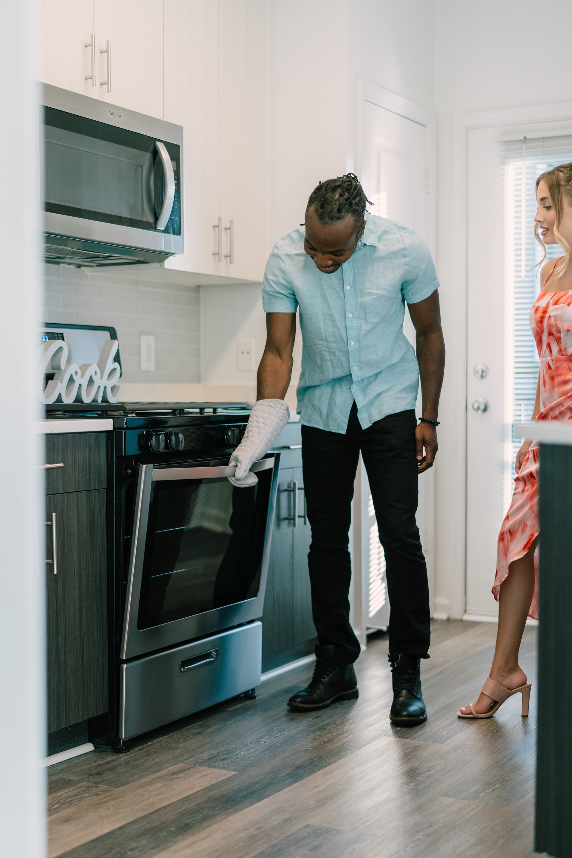 couple using stove in Sullivan Place apartment kitchen