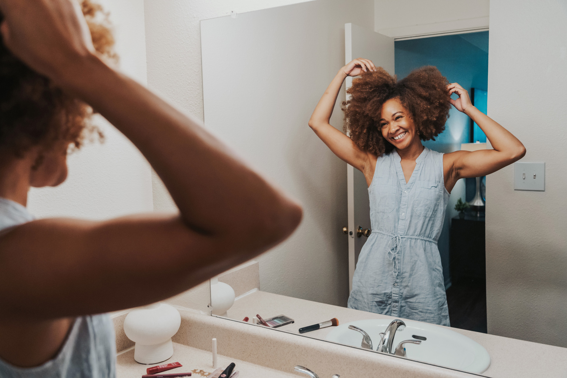 Summit West woman does hair in bathroom