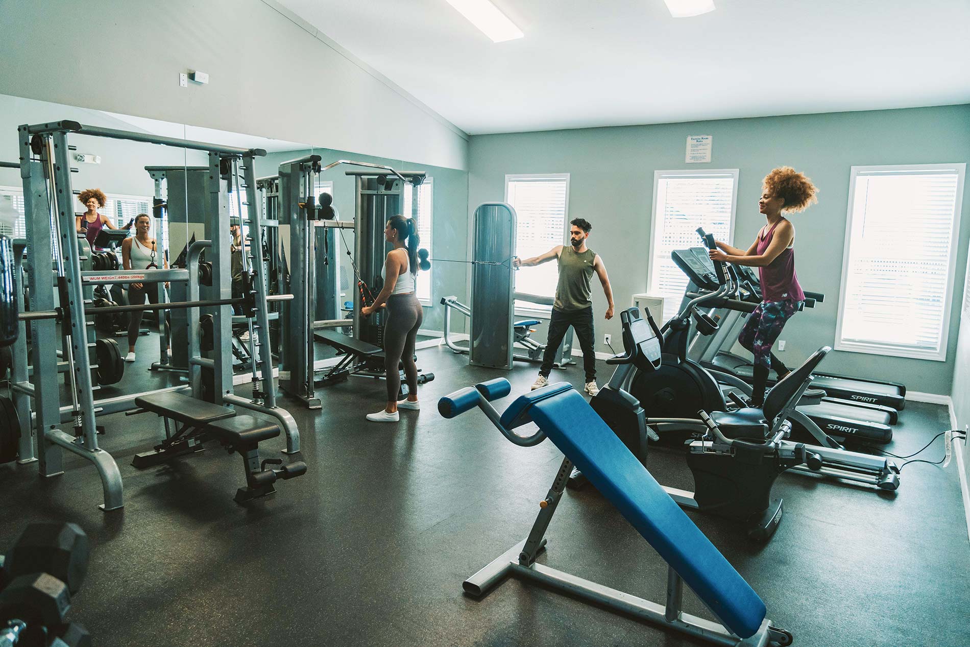 Summit West three people work on in gym