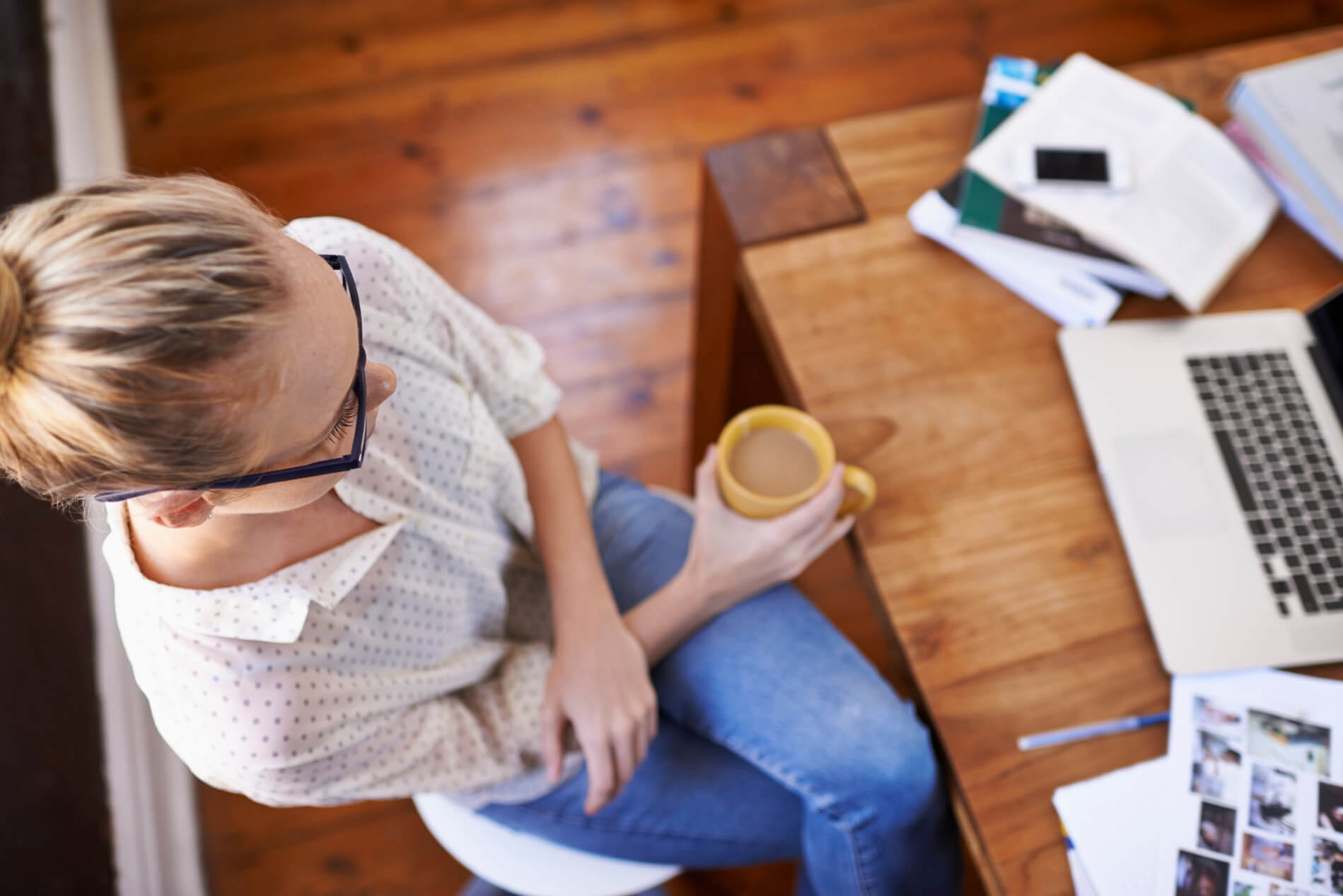 Woman drinking coffee sitting at table