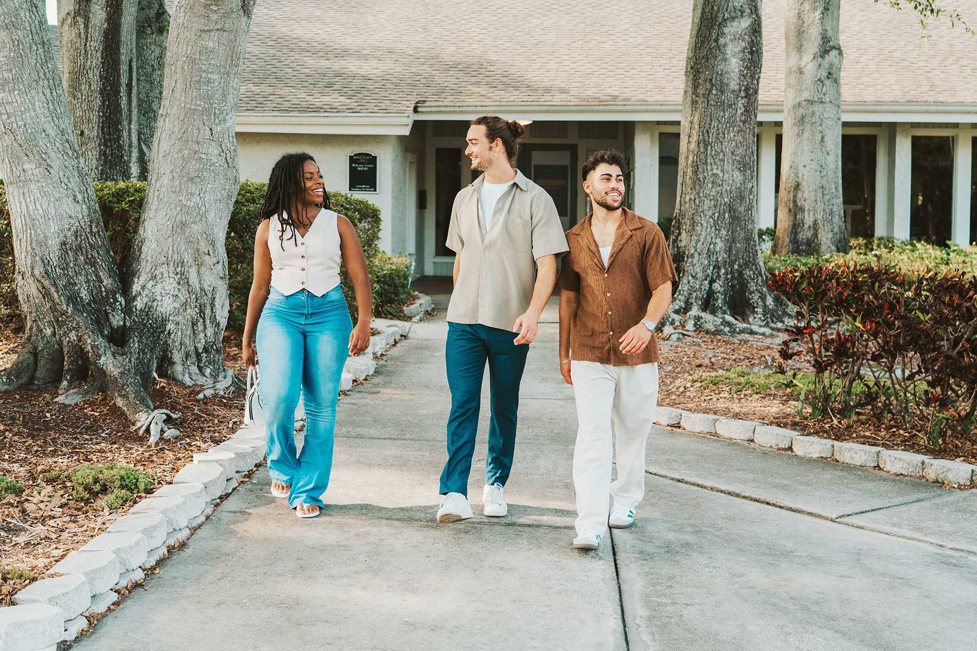 The Breyley three people walk around property