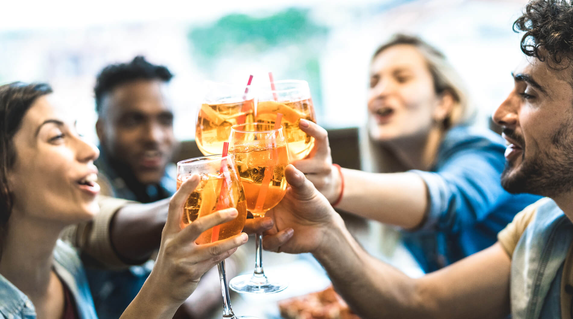 Friends celebrating with drinks outside