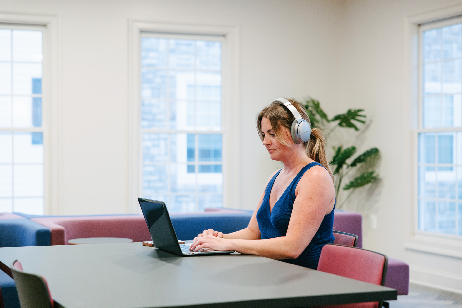 Courts At Dulles woman works in co-working lounge