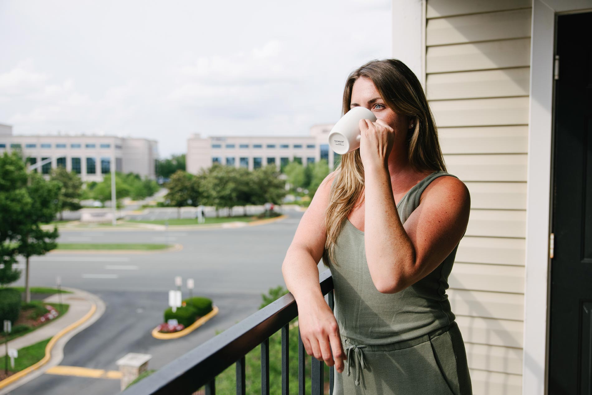Courts at Dulles woman drinks coffee on patio