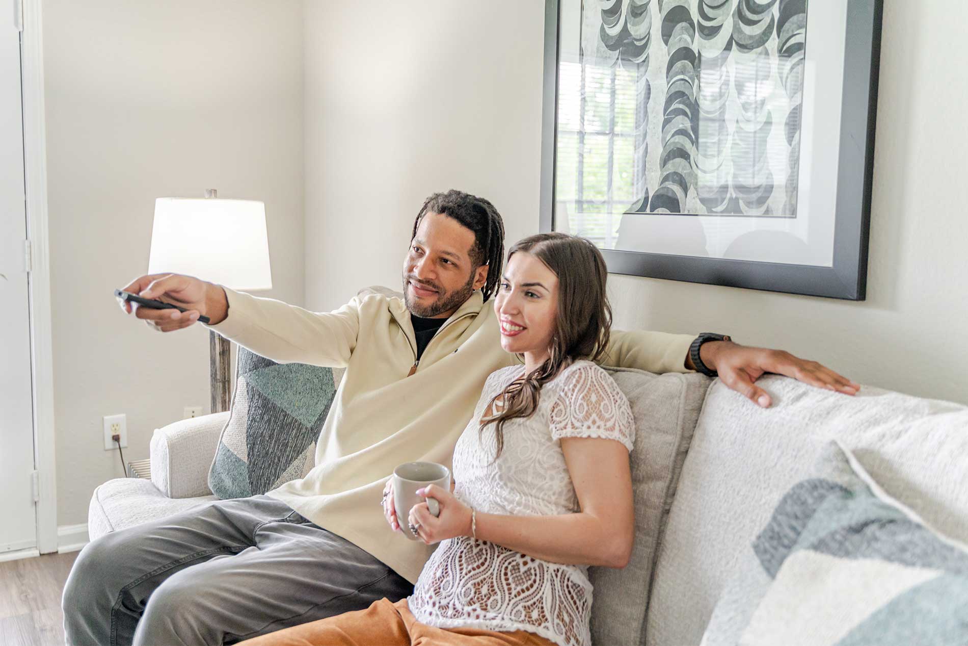 Young man and woman sitting on couch