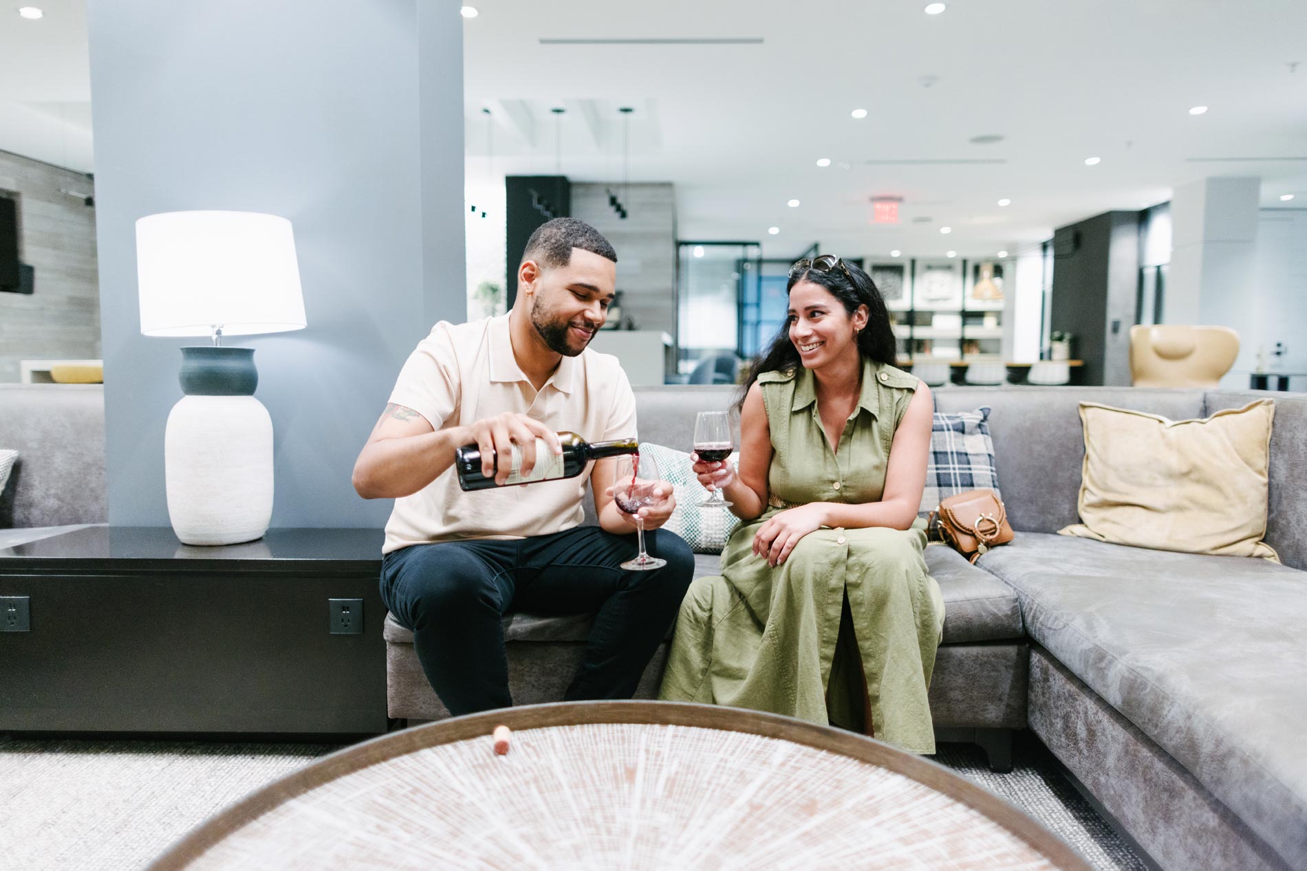 The Enclave a man and woman drink red wine in the clubhouse