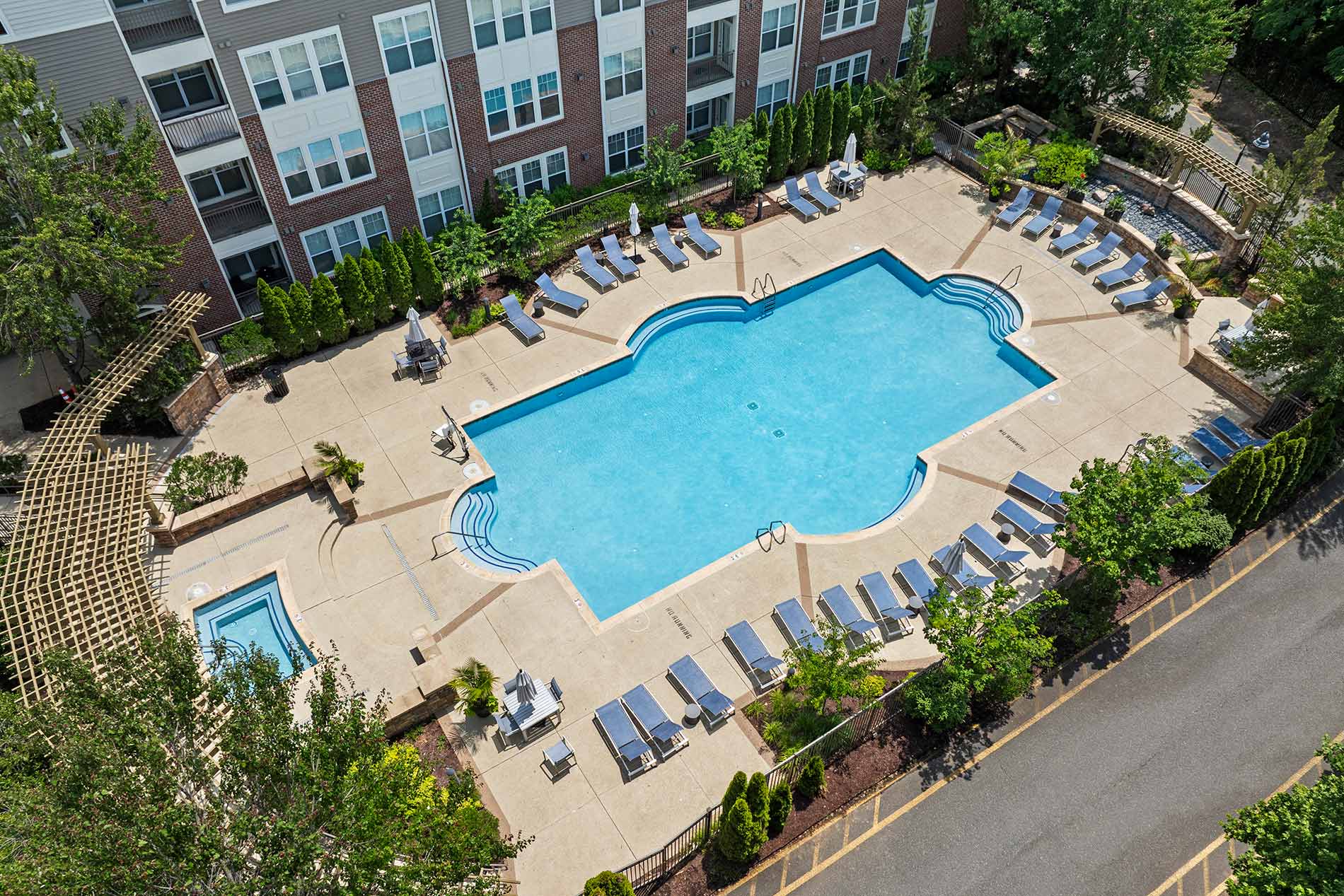 The Enclave aerial building exterior and pool