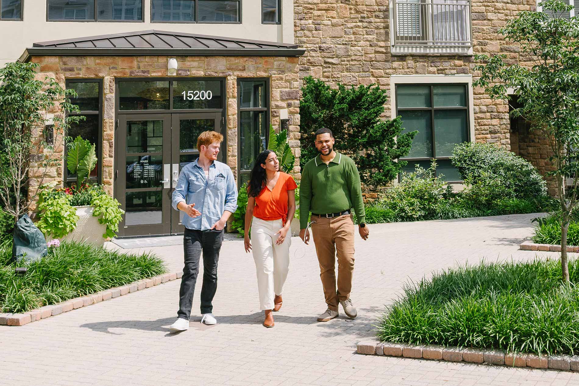 The Enclave three people walk by building