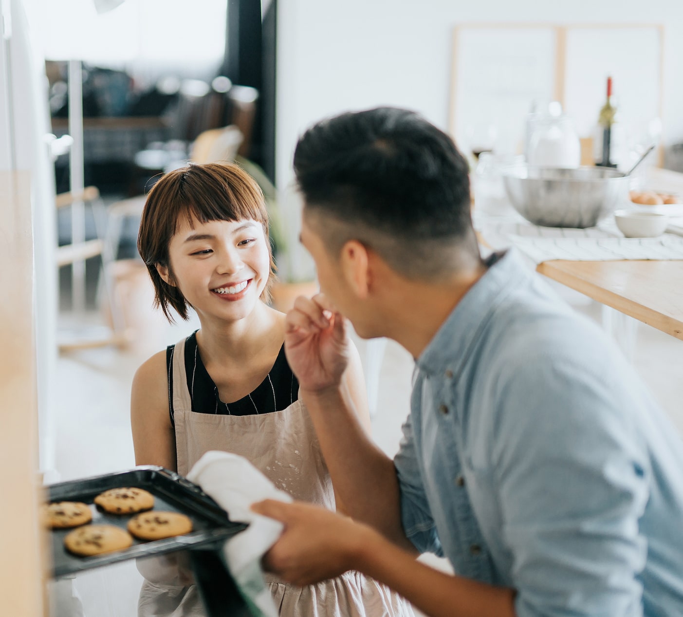 Couple in kitchen baking cookies