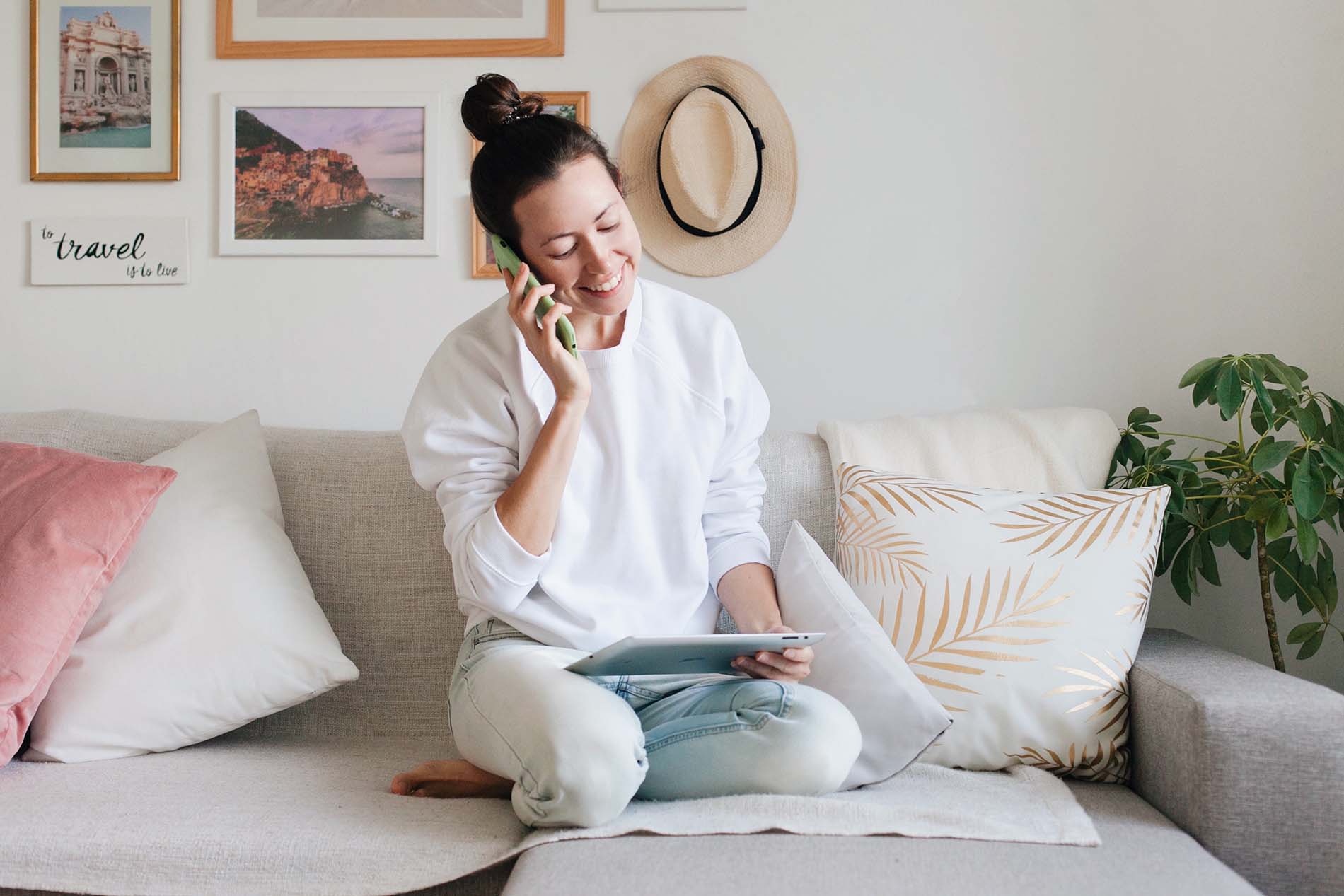 Woman sitting on couch talking on the phone