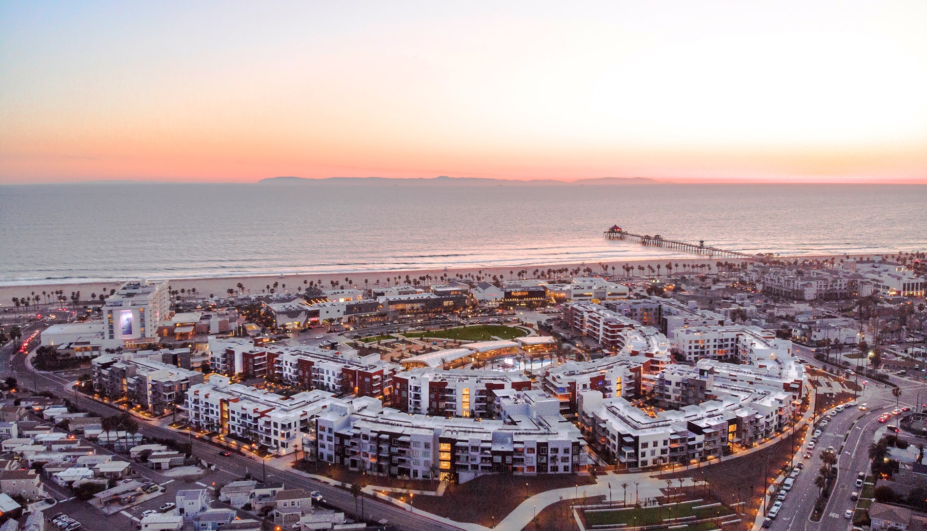 The Residences at Pacific City Apartments Aerial Image of Property, Beach, and Huntington Pier The Residences at Pacific City Apartments Aerial Image of Property, Beach, and Huntington Pier
