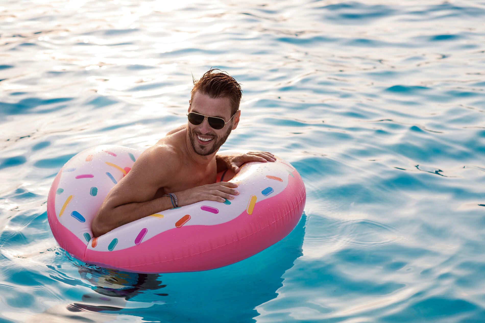 Man in pool float