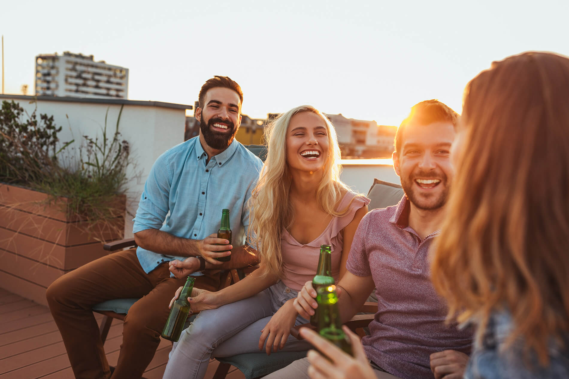 Friends laughing on rooftop deck