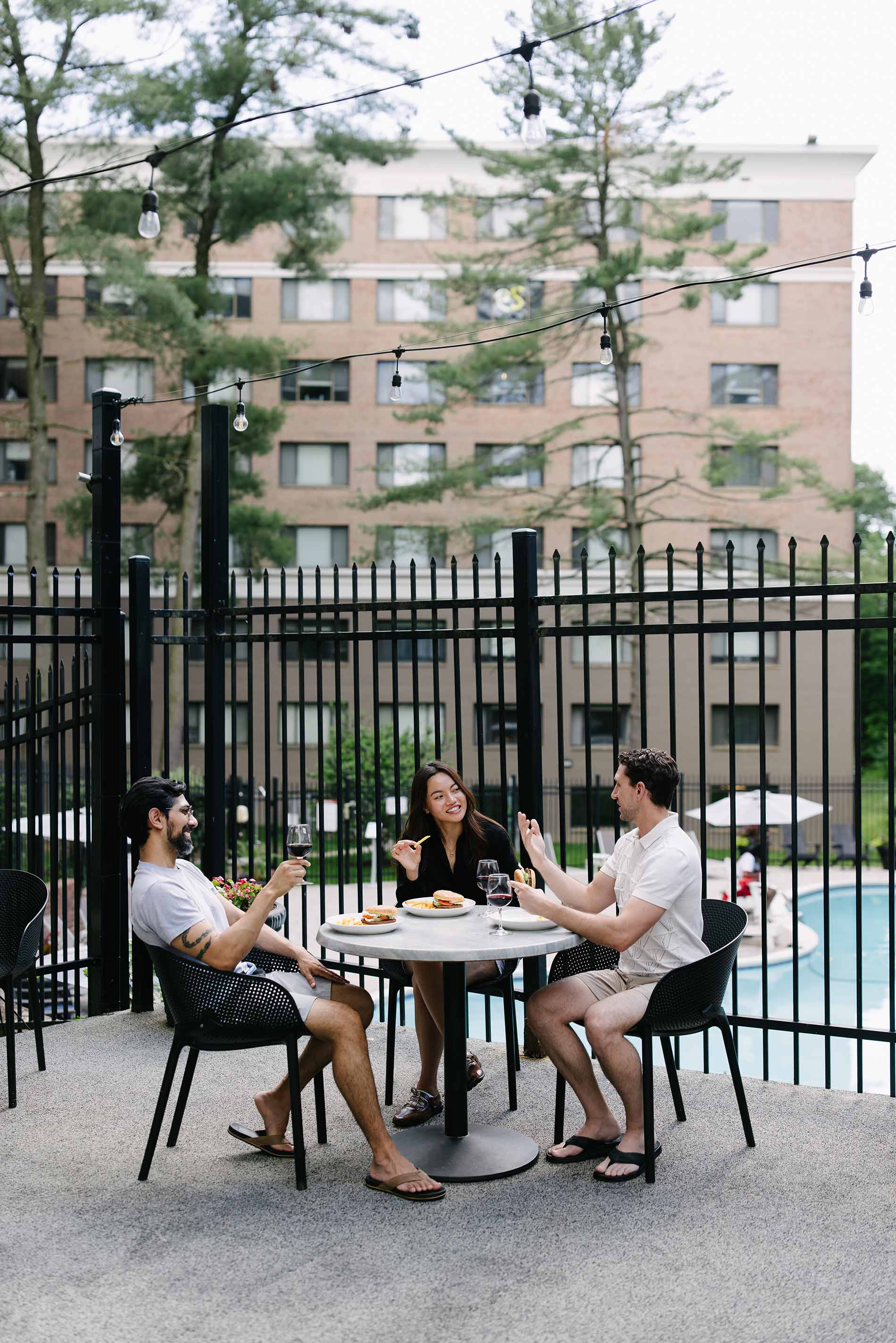 Whitmore apartments three people have hamburgers