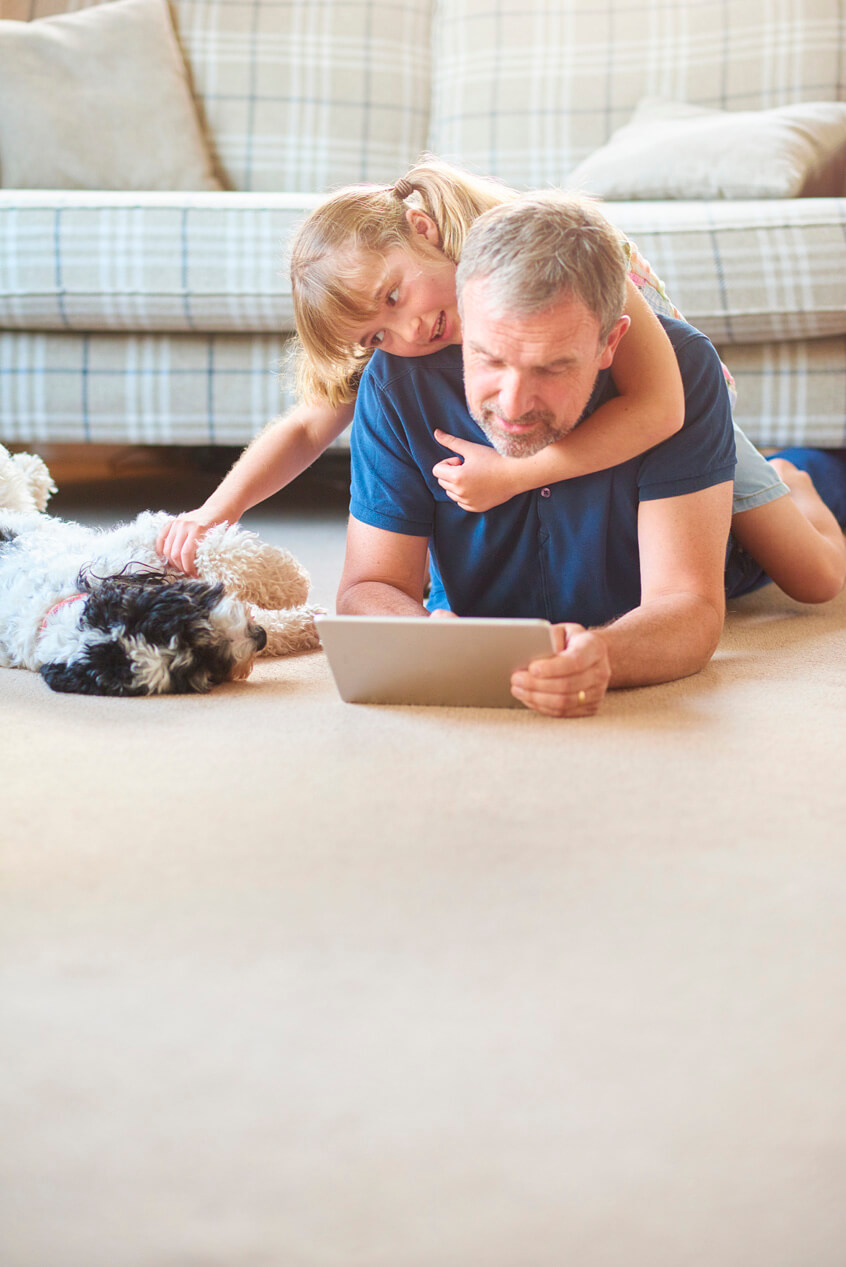 People laying on the floor with a dog