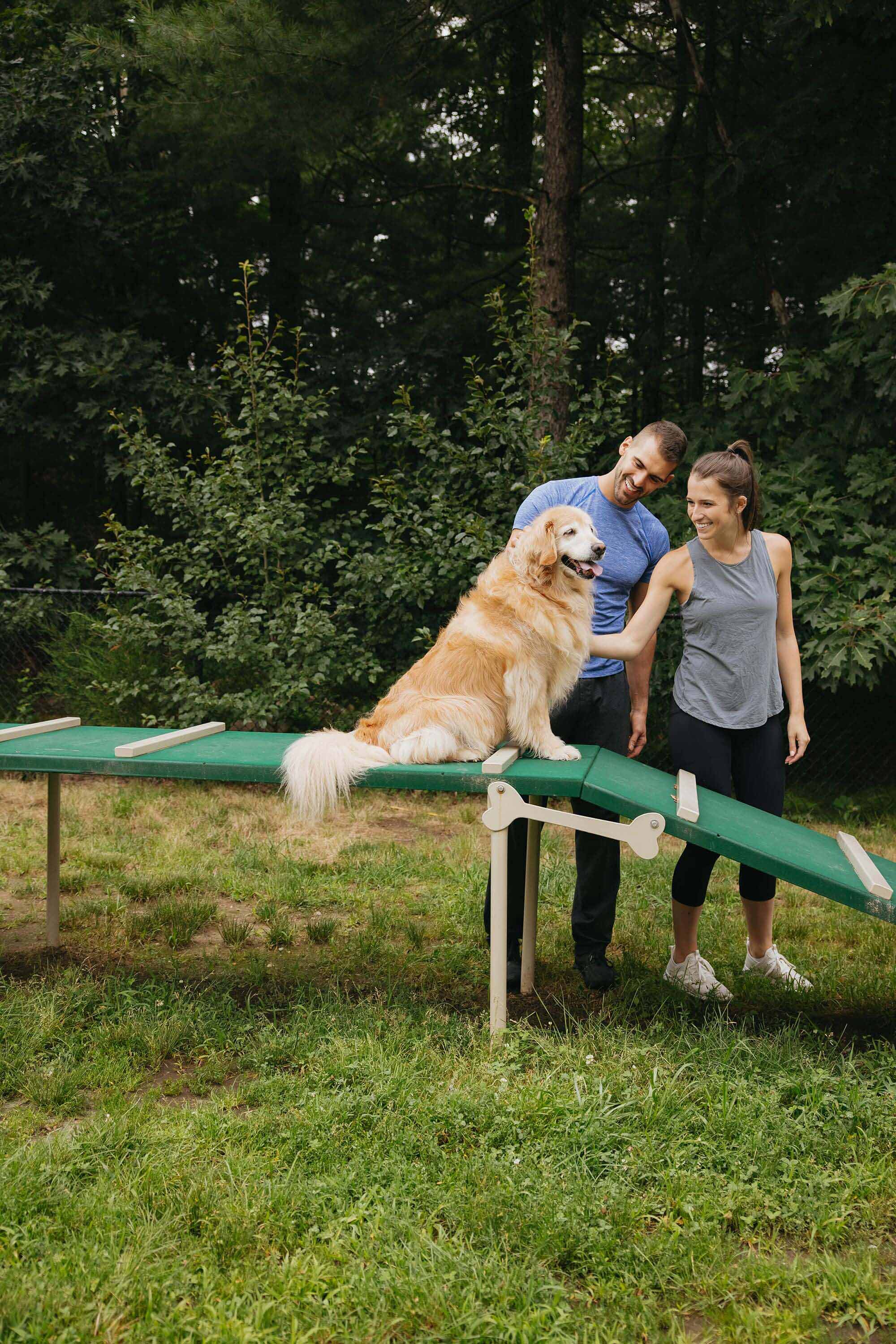 Union Place man and woman with golden retriever in dog park