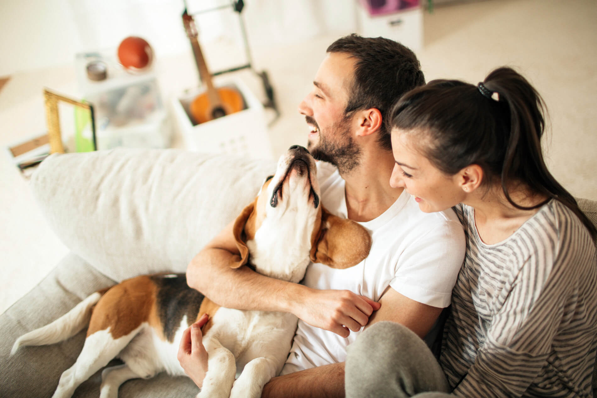 Couple sitting on the couch with their dog