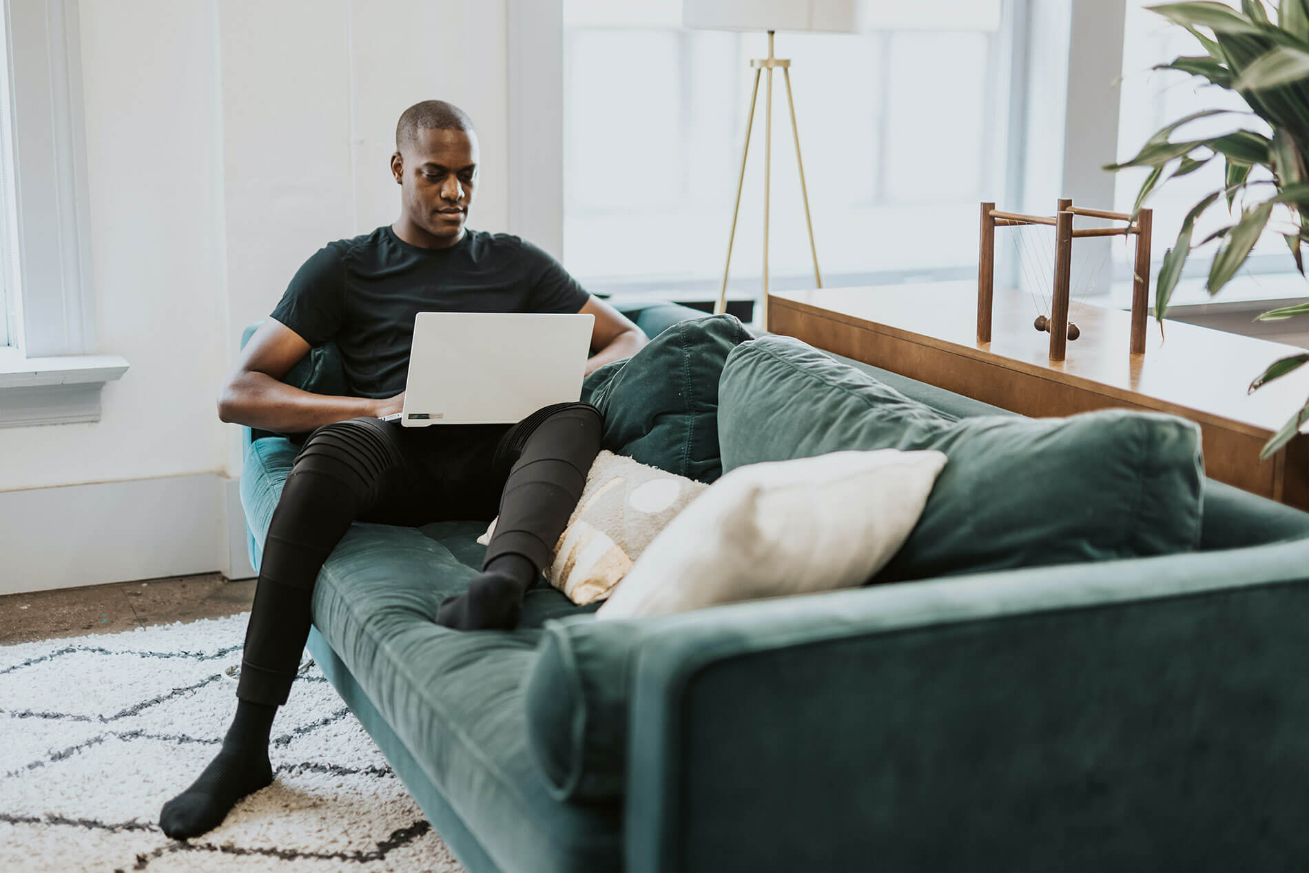 Young man on computer on couch