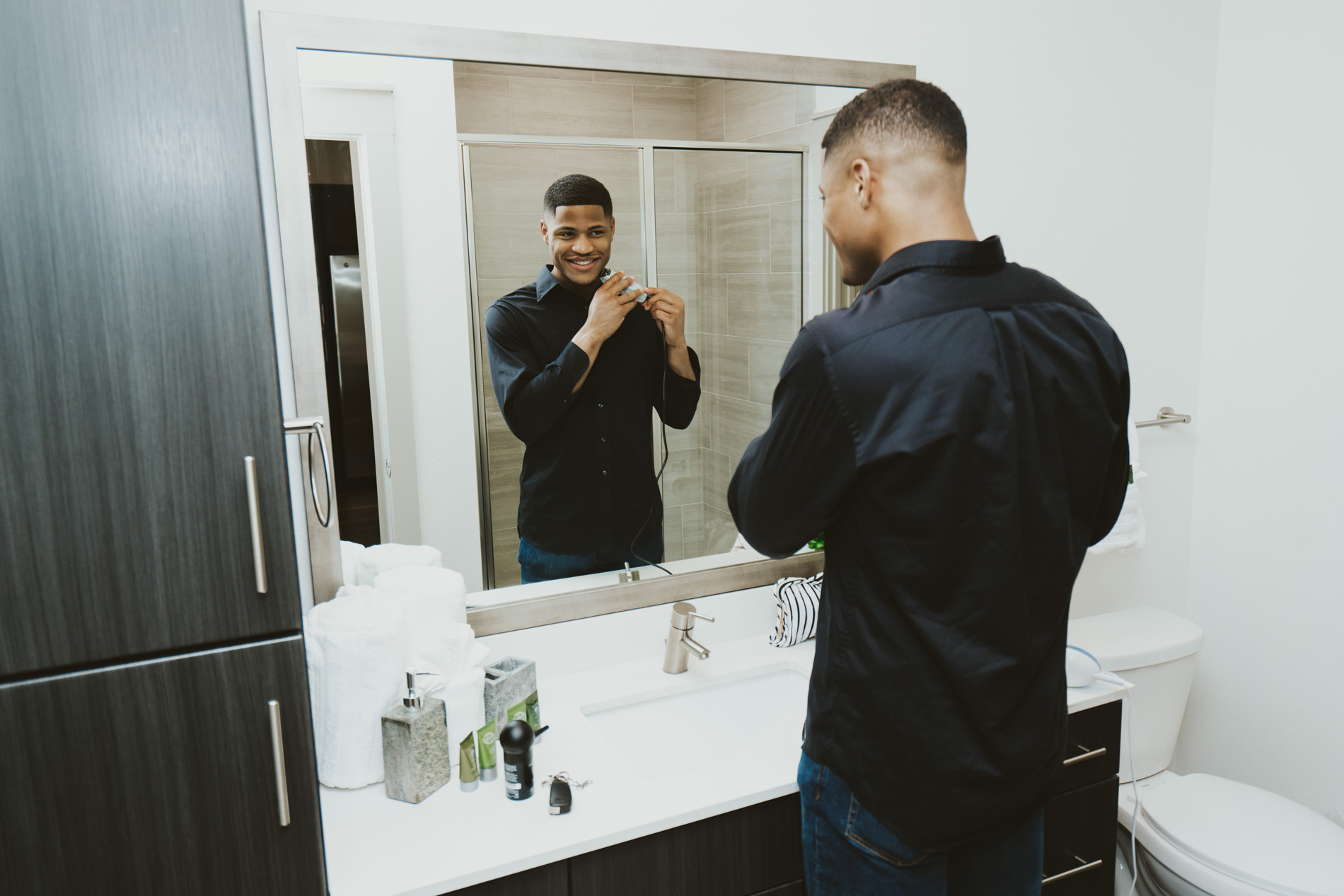 Vitruvian West man in bathroom shaving