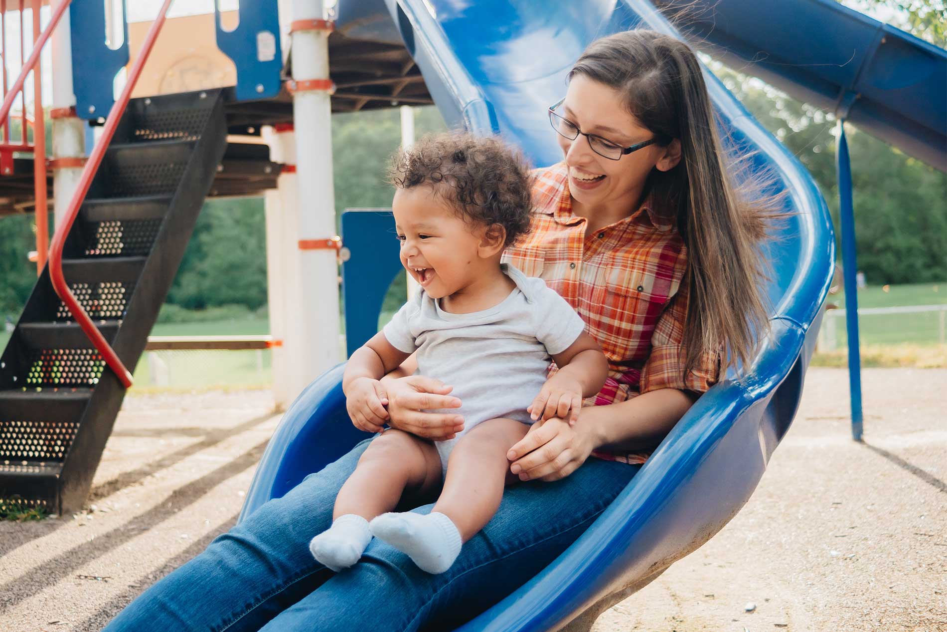 Mother and young son on the slide