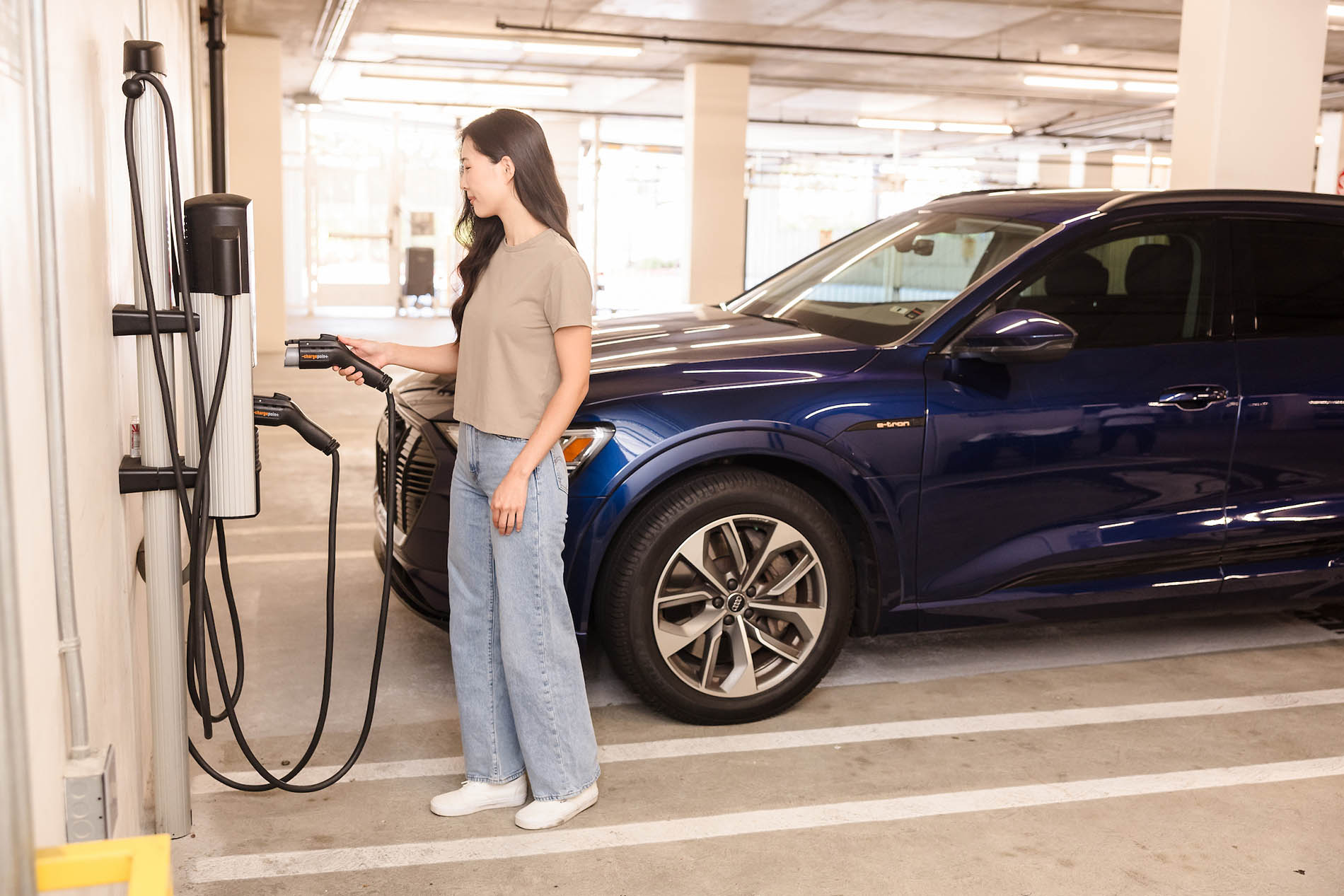 Woman standing at EV Charging station