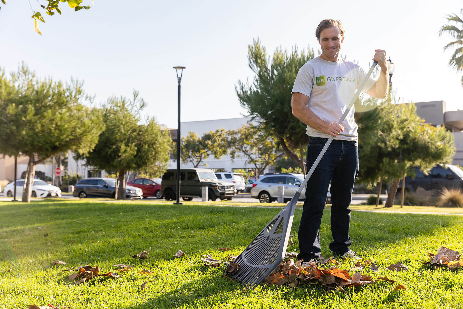 man raking leaves