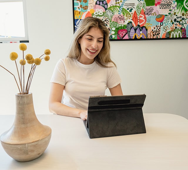 Woman on tablet sitting at table