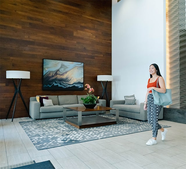 Woman walking in lobby at apartment community