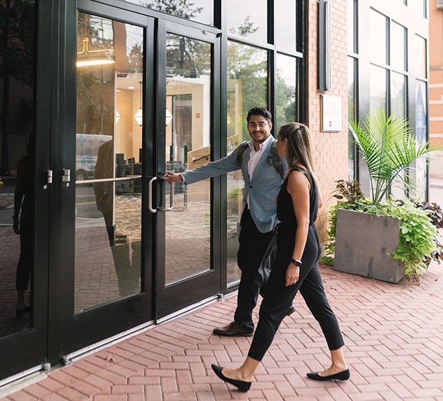 Woman and man entering apartment community