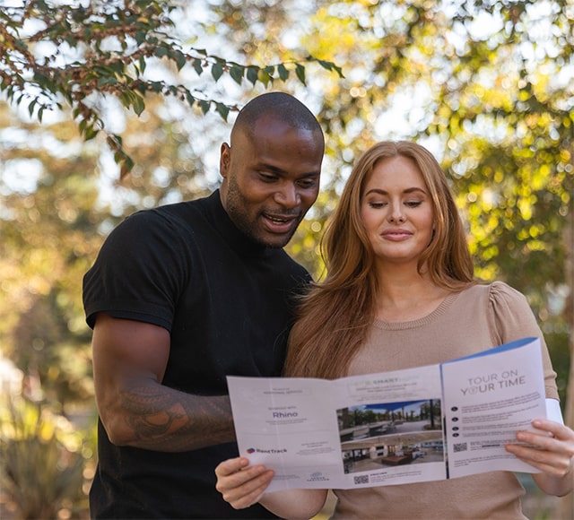 Couple taking self-guided tour with trees in background