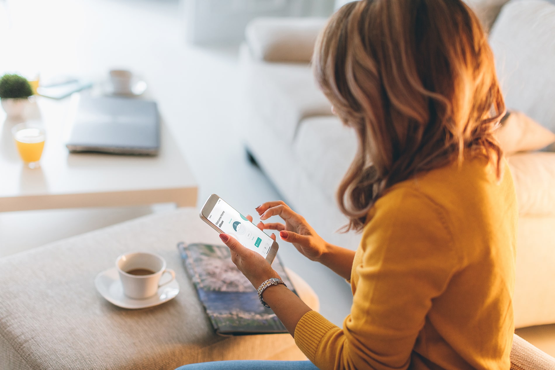 a woman sitting on a couch using a tablet